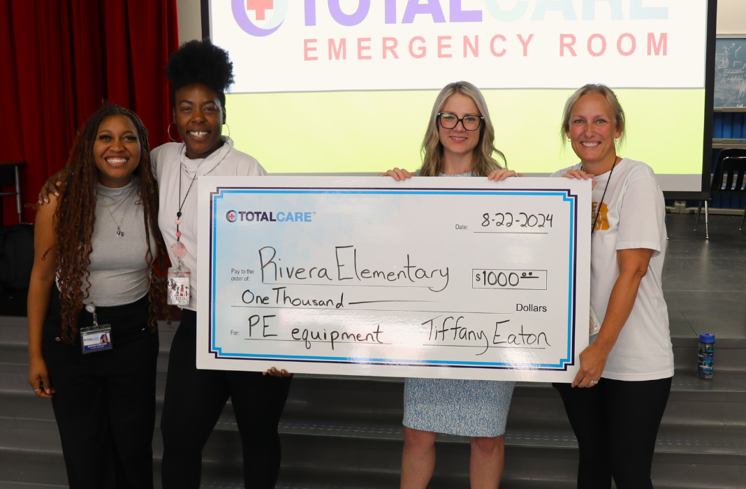  Staff posing with big check